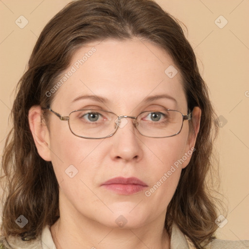 Joyful white adult female with medium  brown hair and blue eyes