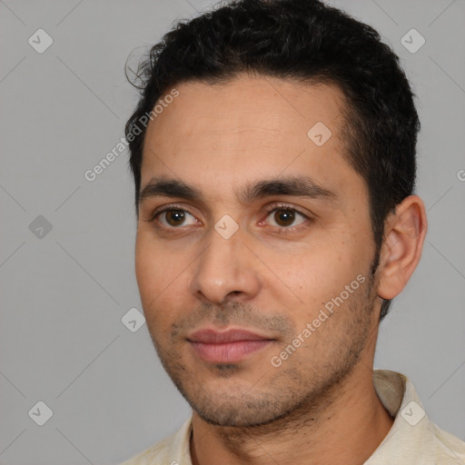 Joyful white young-adult male with short  black hair and brown eyes