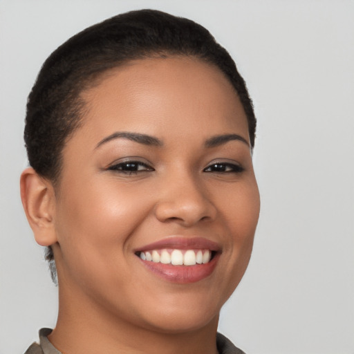 Joyful latino young-adult female with short  brown hair and brown eyes