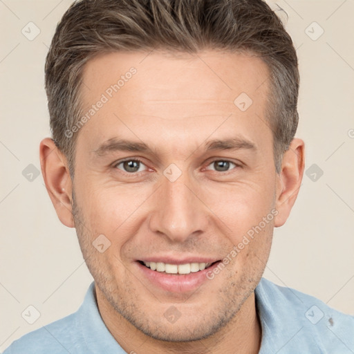 Joyful white adult male with short  brown hair and brown eyes