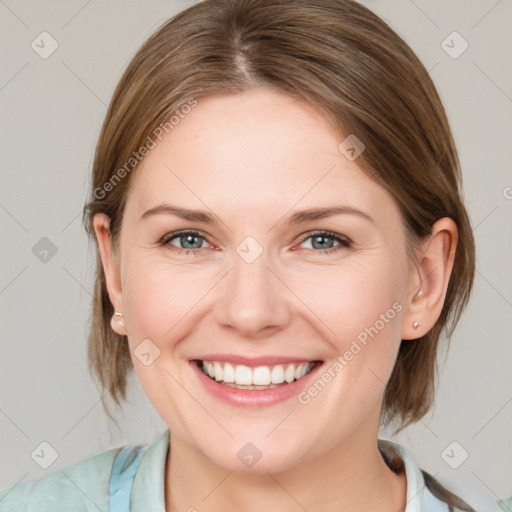 Joyful white young-adult female with medium  brown hair and blue eyes