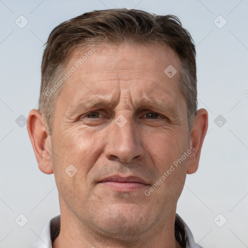 Joyful white middle-aged male with short  brown hair and brown eyes