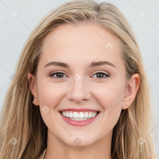 Joyful white young-adult female with long  brown hair and blue eyes