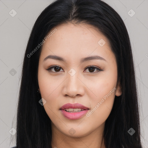 Joyful asian young-adult female with long  black hair and brown eyes