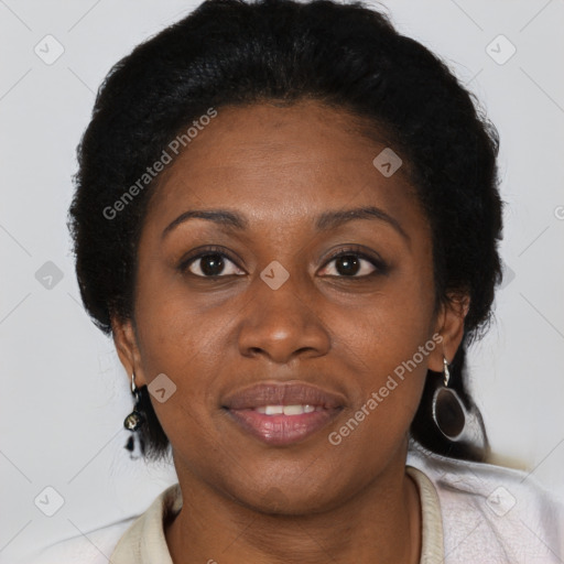 Joyful black adult female with short  brown hair and brown eyes