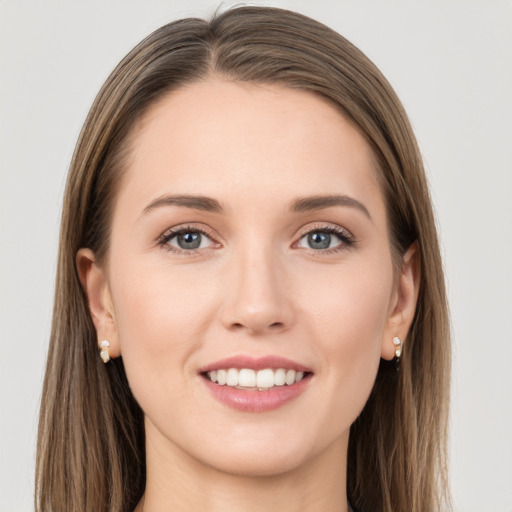 Joyful white young-adult female with long  brown hair and grey eyes