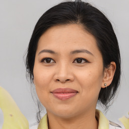 Joyful asian adult female with medium  brown hair and brown eyes