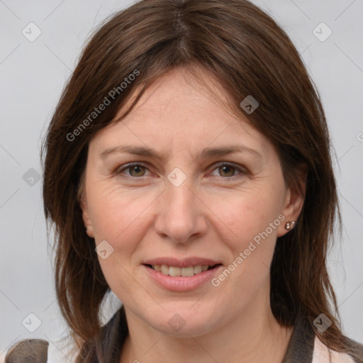 Joyful white adult female with medium  brown hair and grey eyes