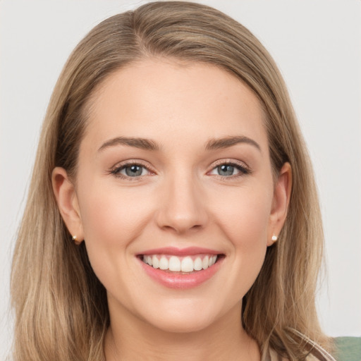 Joyful white young-adult female with long  brown hair and grey eyes