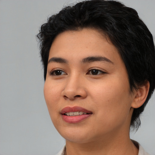 Joyful asian young-adult female with medium  black hair and brown eyes