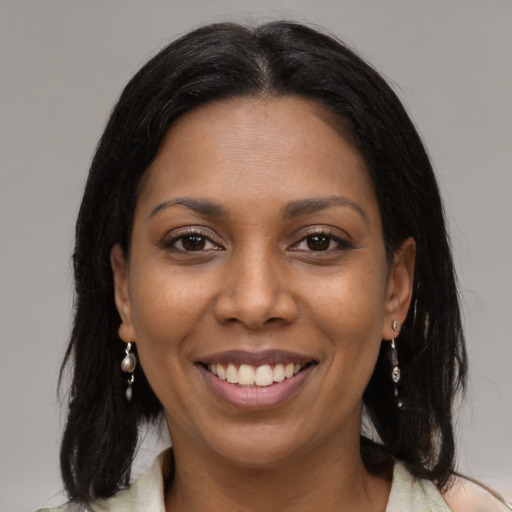 Joyful black young-adult female with medium  black hair and brown eyes