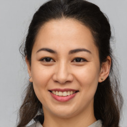 Joyful asian young-adult female with medium  brown hair and brown eyes