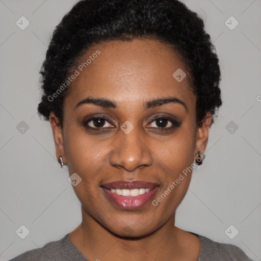 Joyful black young-adult female with short  black hair and brown eyes