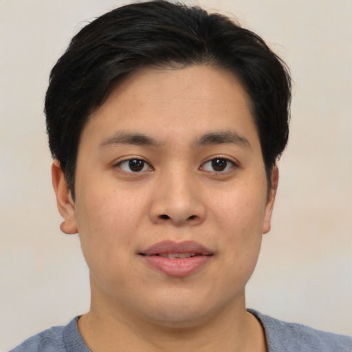 Joyful asian young-adult male with short  brown hair and brown eyes