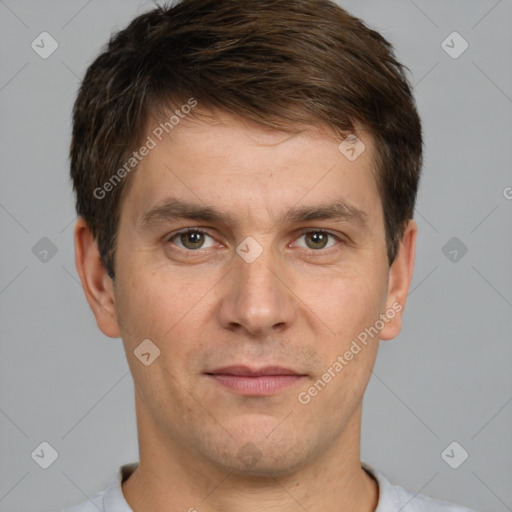 Joyful white young-adult male with short  brown hair and grey eyes