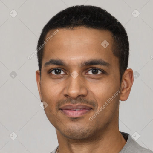 Joyful black young-adult male with short  black hair and brown eyes