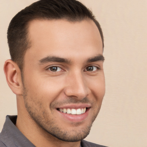 Joyful white young-adult male with short  brown hair and brown eyes