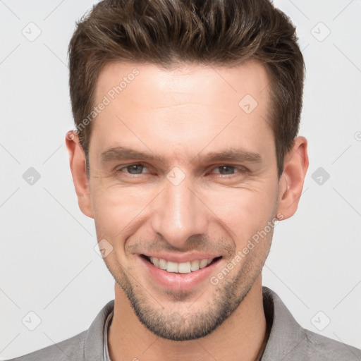 Joyful white adult male with short  brown hair and brown eyes