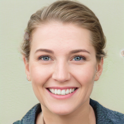 Joyful white young-adult female with short  brown hair and blue eyes