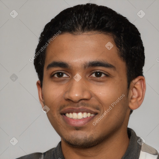 Joyful latino young-adult male with short  black hair and brown eyes