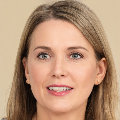 Joyful white young-adult female with long  brown hair and grey eyes