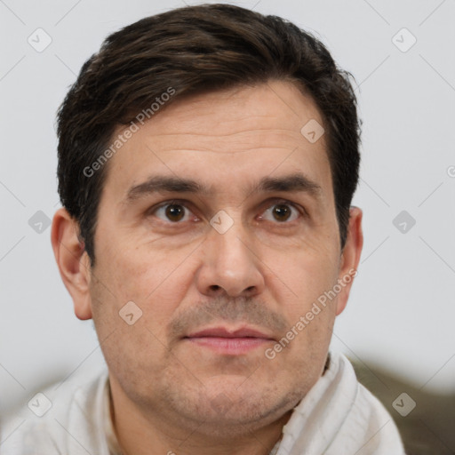 Joyful white adult male with short  brown hair and brown eyes