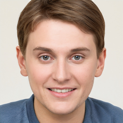 Joyful white young-adult male with short  brown hair and blue eyes