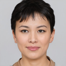 Joyful asian young-adult female with short  brown hair and brown eyes