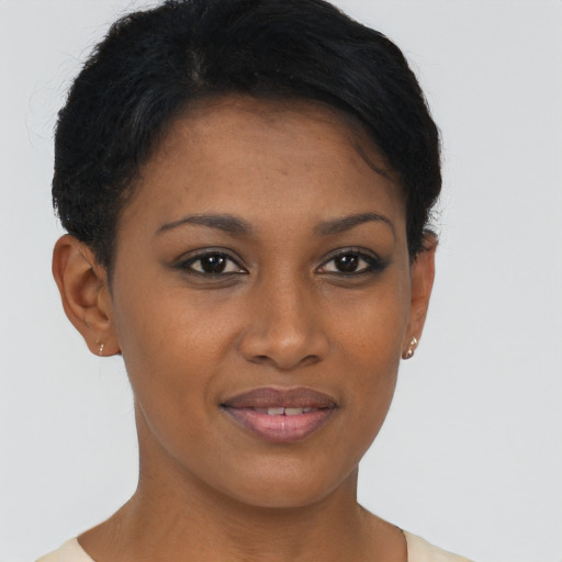 Joyful black young-adult female with short  brown hair and brown eyes