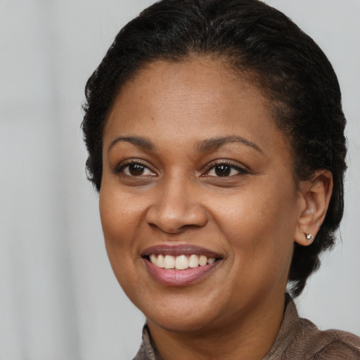 Joyful latino young-adult female with short  brown hair and brown eyes