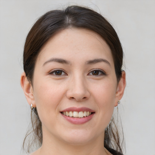 Joyful white young-adult female with medium  brown hair and brown eyes