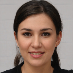 Joyful white young-adult female with medium  brown hair and brown eyes