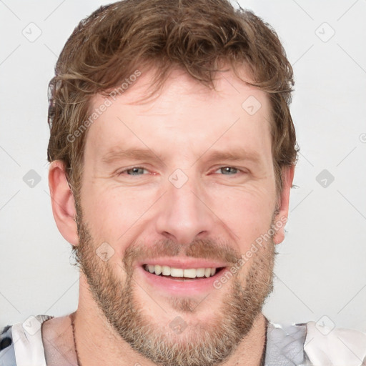 Joyful white adult male with short  brown hair and grey eyes