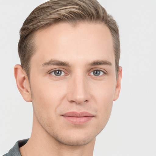 Joyful white young-adult male with short  brown hair and grey eyes