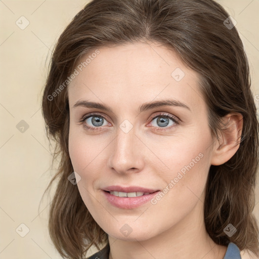 Joyful white young-adult female with medium  brown hair and blue eyes