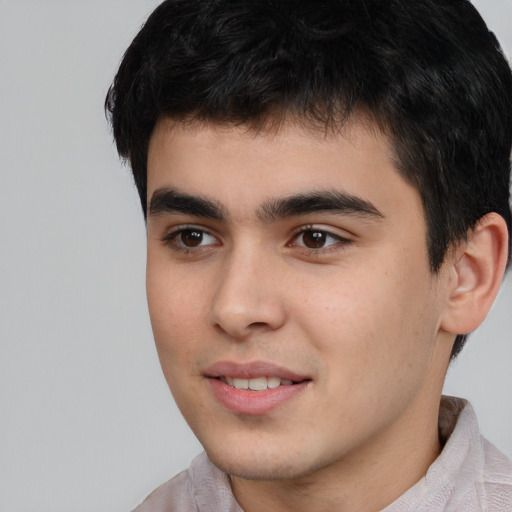 Joyful asian young-adult male with short  brown hair and brown eyes