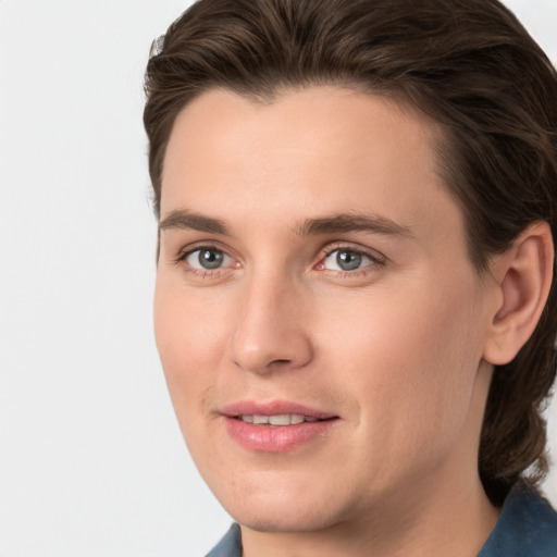 Joyful white young-adult male with medium  brown hair and grey eyes