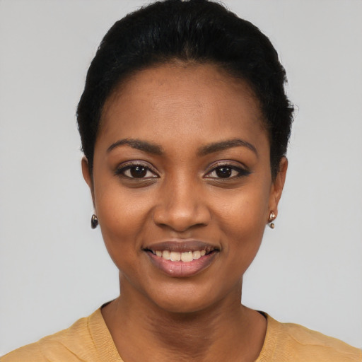 Joyful black young-adult female with short  black hair and brown eyes