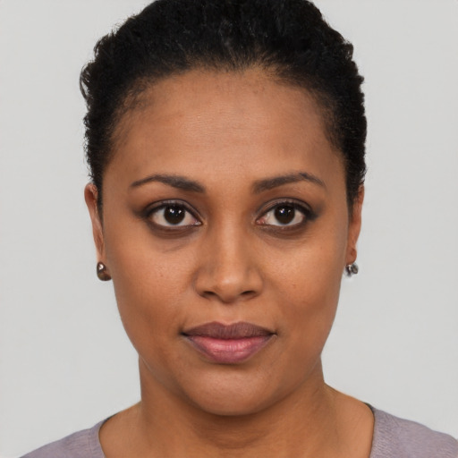 Joyful black young-adult female with short  brown hair and brown eyes