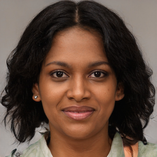 Joyful black young-adult female with medium  brown hair and brown eyes