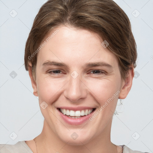 Joyful white young-adult female with short  brown hair and grey eyes