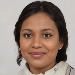 Joyful latino young-adult female with medium  brown hair and brown eyes