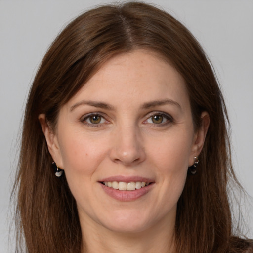 Joyful white young-adult female with long  brown hair and grey eyes