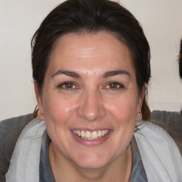 Joyful white adult female with medium  brown hair and brown eyes