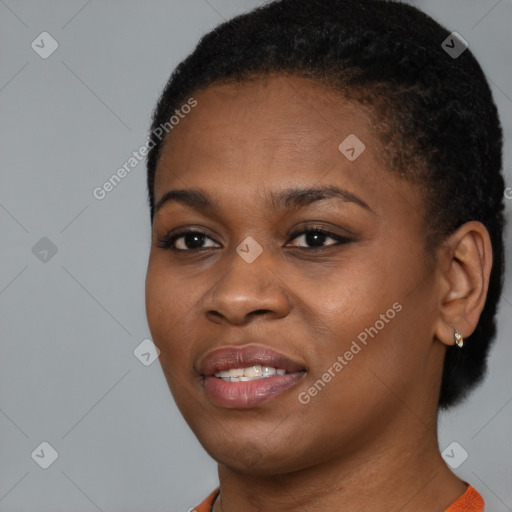 Joyful black young-adult female with short  black hair and brown eyes