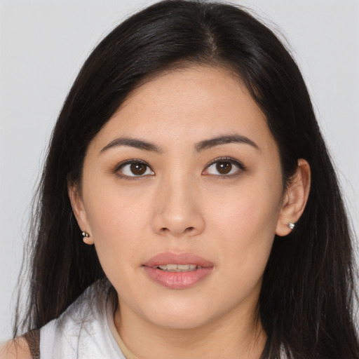 Joyful asian young-adult female with long  brown hair and brown eyes