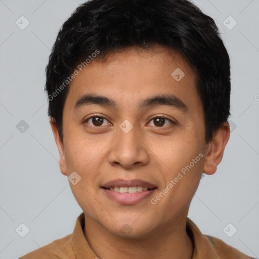 Joyful latino young-adult male with short  brown hair and brown eyes