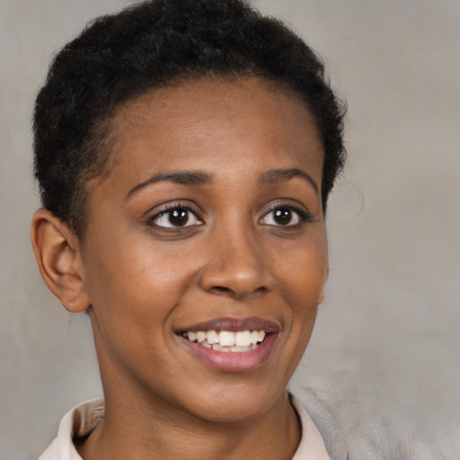 Joyful black young-adult female with short  brown hair and brown eyes