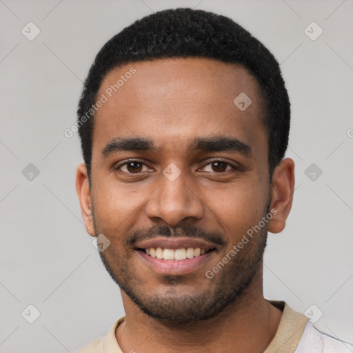 Joyful black young-adult male with short  black hair and brown eyes