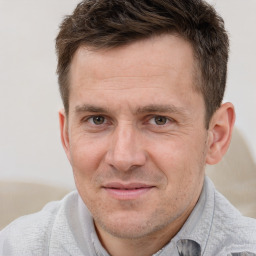 Joyful white adult male with short  brown hair and brown eyes